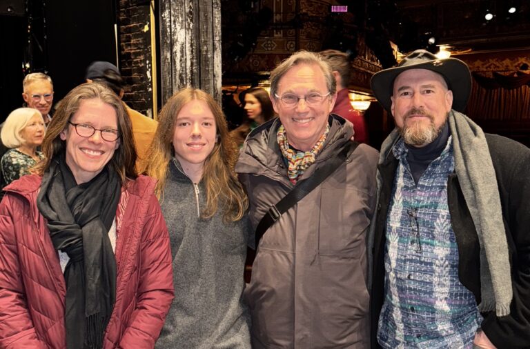 Deanna & Mason LaMotte, Richard Thomas, and David LaMotte, arm in arm, smiling at the camera